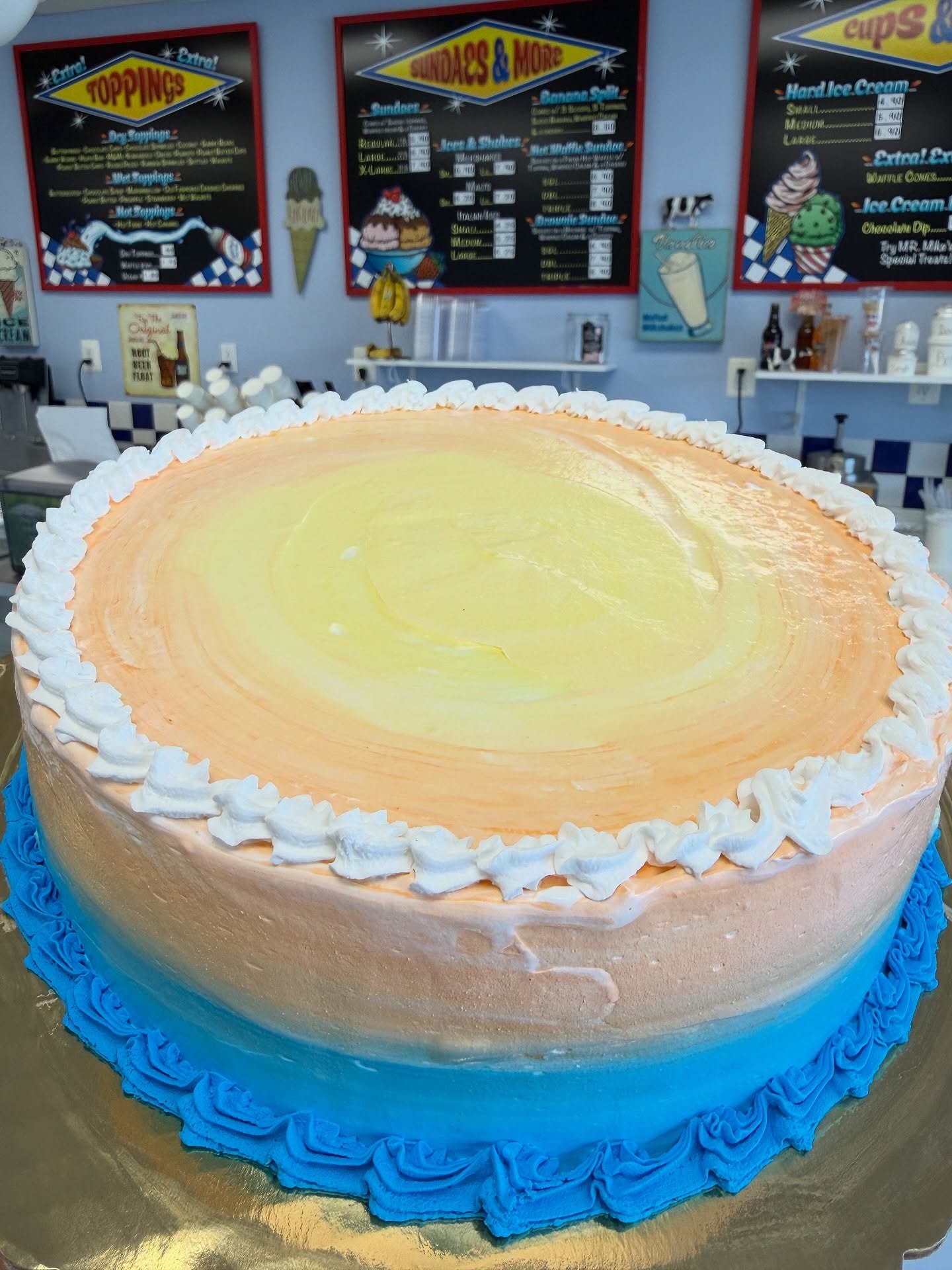 Ice cream birthday cake with pink frosting and flowers